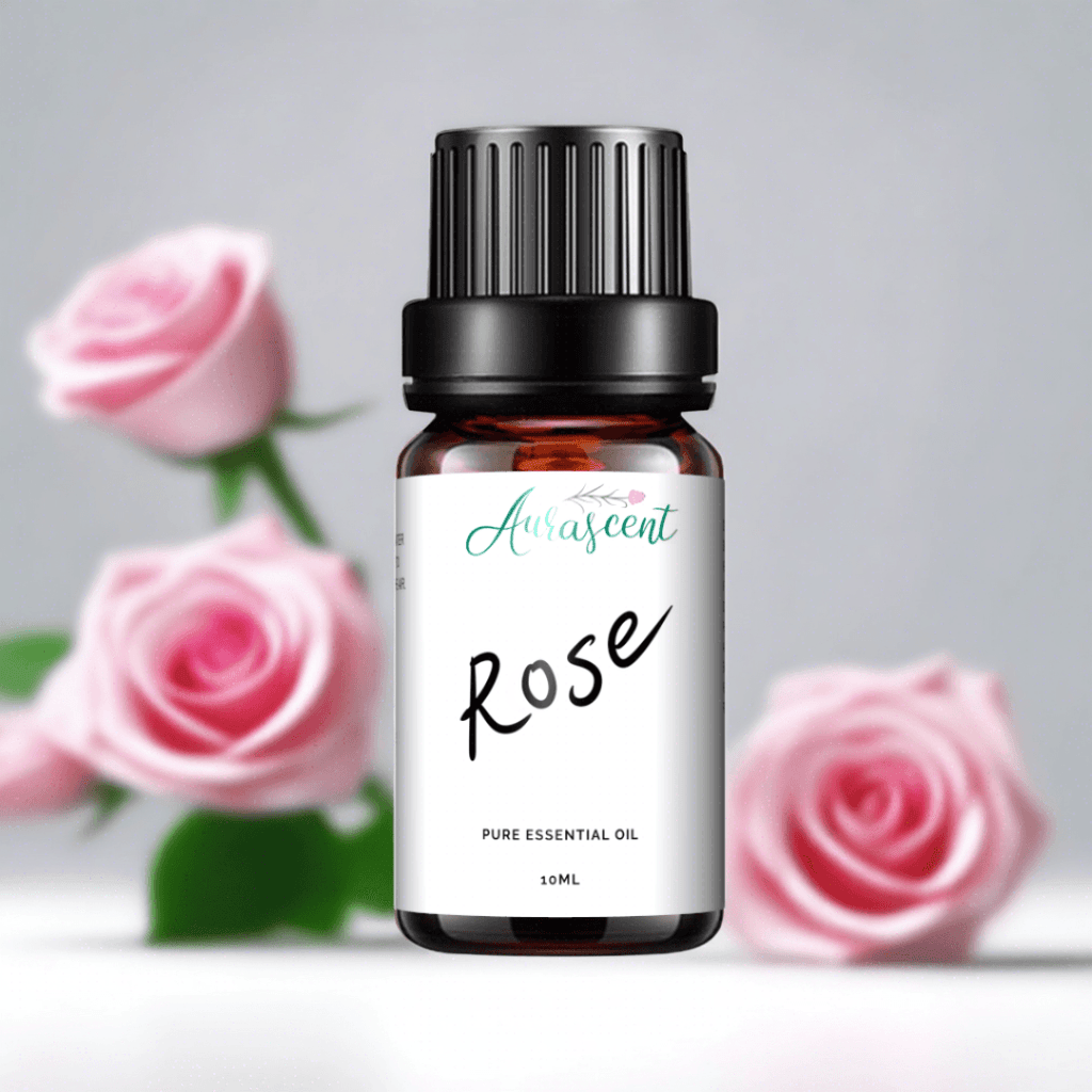 Aurascent Rose Essential Oil 10ml bottle with rose flowers and leaves in a natural setting.