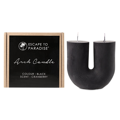 Black cranberry Arch Candle by Escape to Paradise with a sleek, curved design and dark cranberry scent for a cozy ambiance.