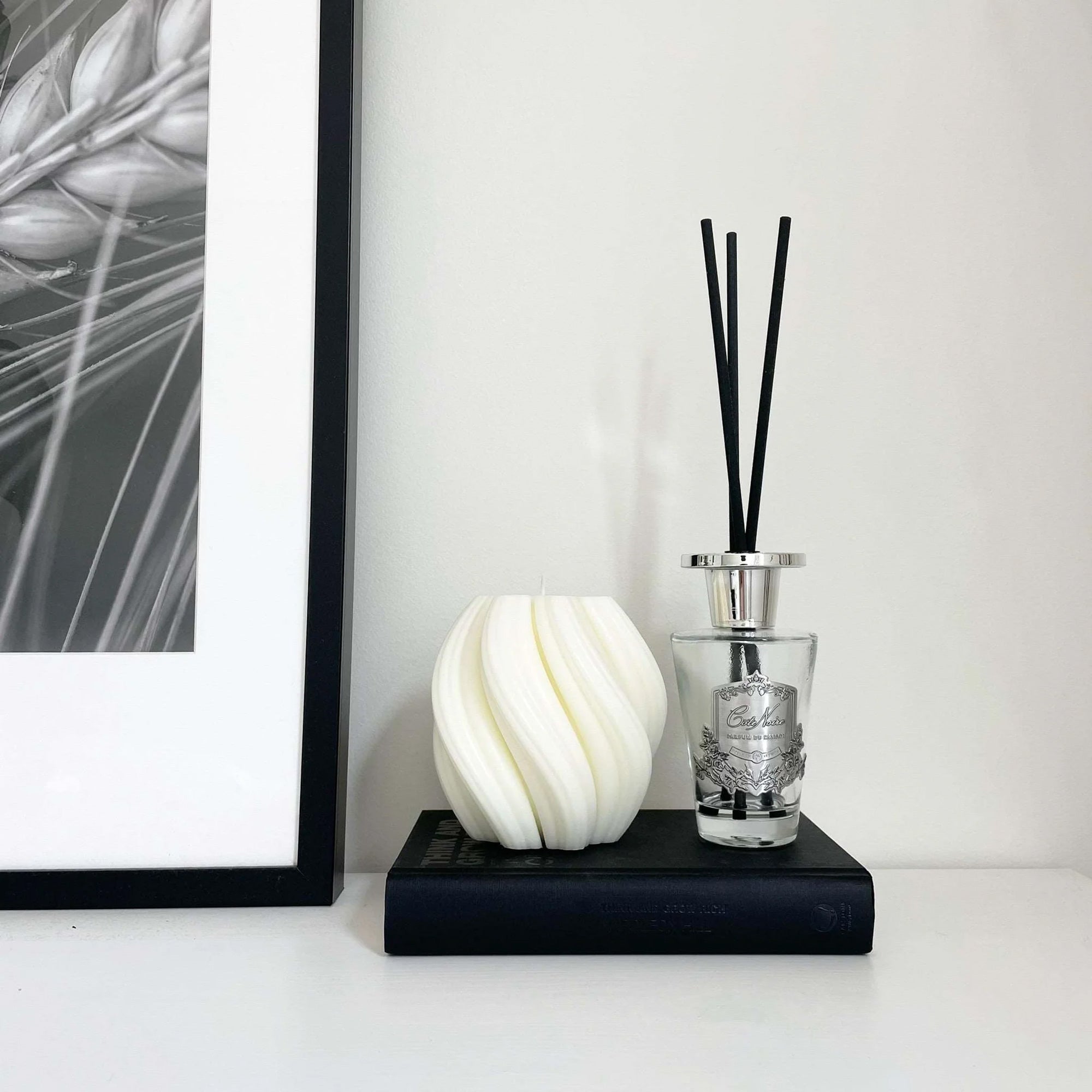 Swirl candle by Escape to Paradise in Lime Basil & Citrus scent, featuring a decorative swirl design and warm glow.