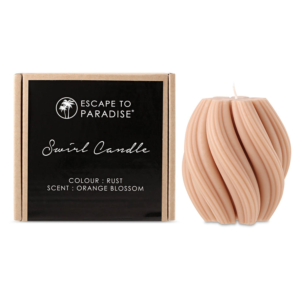 Swirl candle by Escape to Paradise with orange blossom scent, featuring a decorative orange and white swirl design.