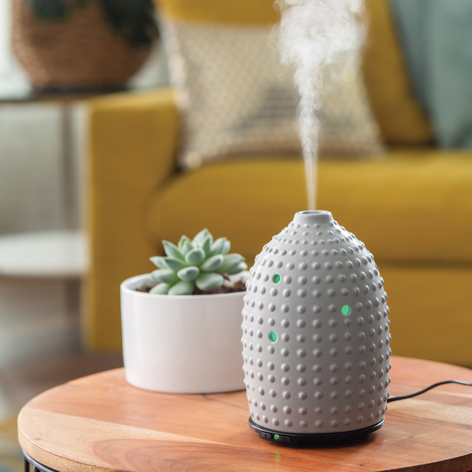 NNE Living Hobnail Ultrasonic Aroma Diffuser emitting mist in a modern home setting.