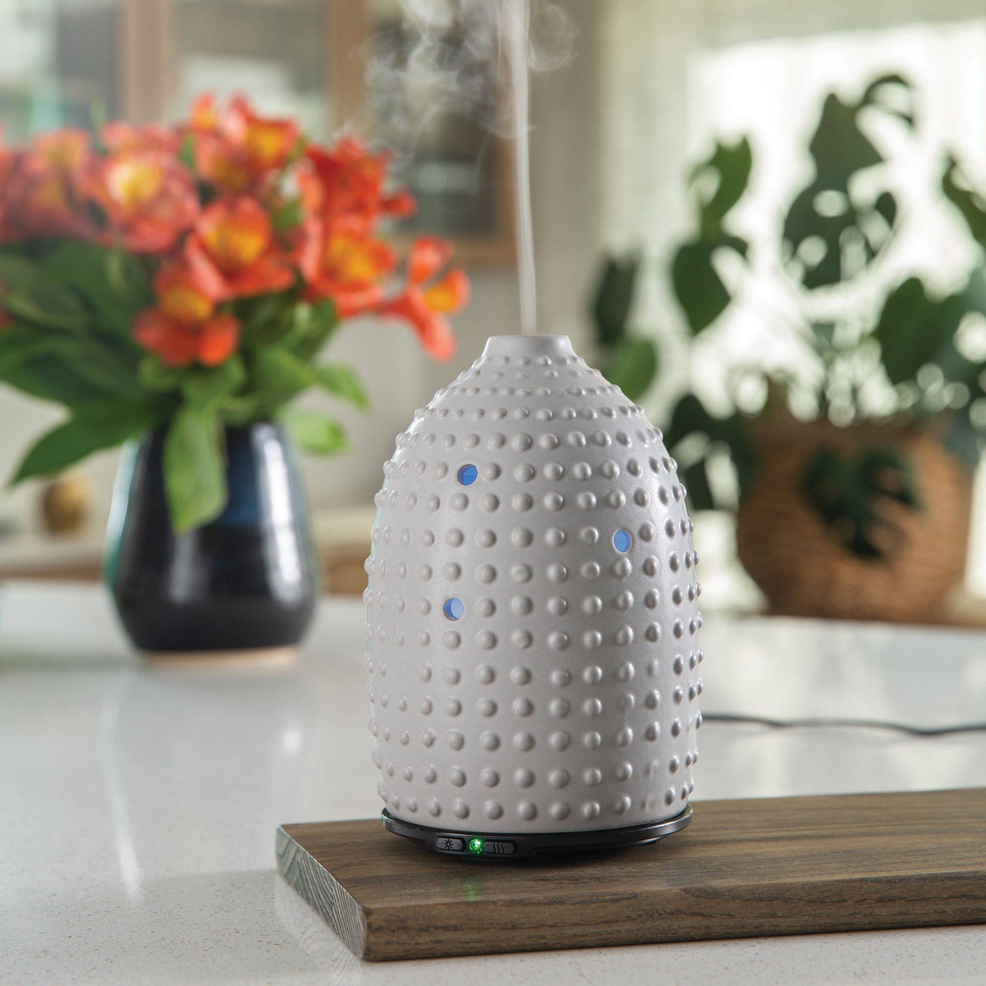 NNE Living Hobnail Ultrasonic Aroma Diffuser displaying a sleek white design with mist and ambient lighting.
