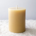 Pure beeswax pillar candle from Serenes Beeswaxory, 10cm tall, with a natural honey color and smooth wax finish.