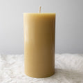 Pure beeswax pillar candle by Serenes Beeswaxory, 15cm tall, showcasing natural beeswax texture and warm candle glow.