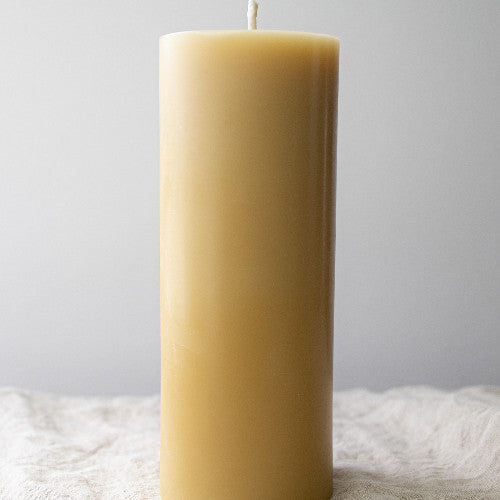 Serenes Beeswaxory pure beeswax pillar candle, 20cm tall, with natural honey-colored wax and a smooth, cylindrical shape.