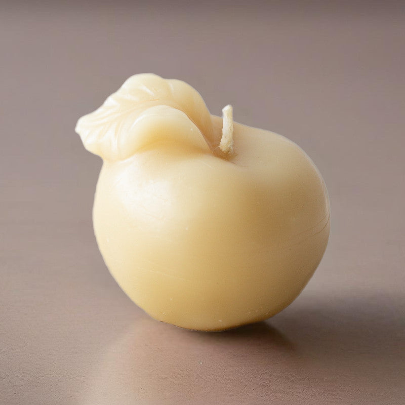 Box of 4 Serenes Beeswaxory pure beeswax Apple candles in golden color, votive style, displayed in a box.