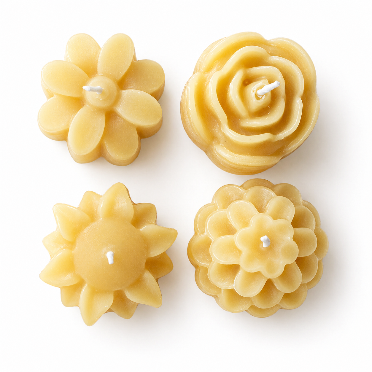 Set of four Serenes Beeswaxory flower-shaped pure beeswax tealight candles in a box, showcasing their natural yellow hue and delicate floral design.