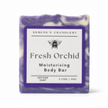 Handmade pure soap with fresh orchid and castor oil, Serenes Beeswaxory skincare essentials, showing the soap bar with floral details.